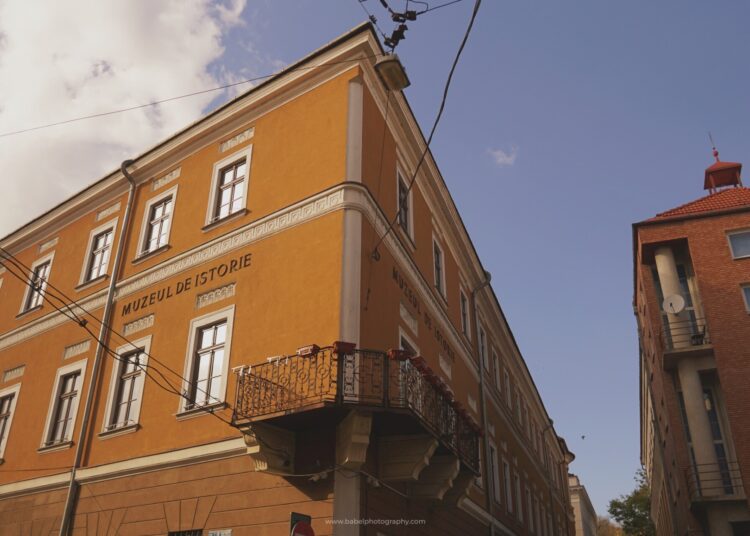 A yellow building with a balcony, dedicated to Transylvanian History.