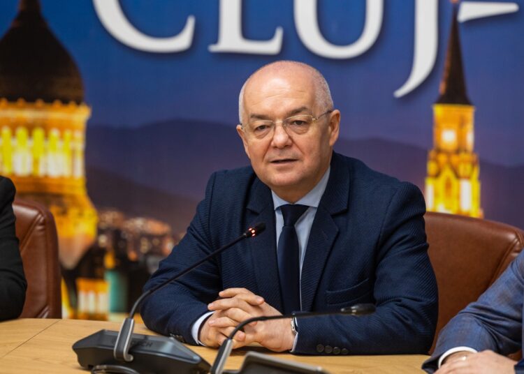Three men, including Emil Boc of Cluj-Napoca, sitting at a table with microphones in front of them.